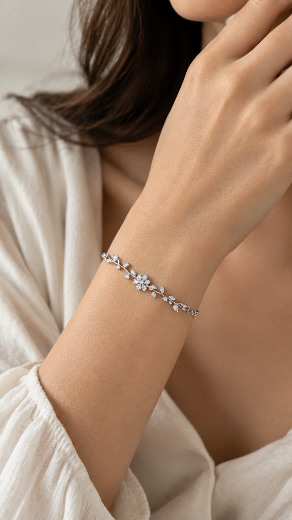 Two arms adorned with delicate silver bracelets