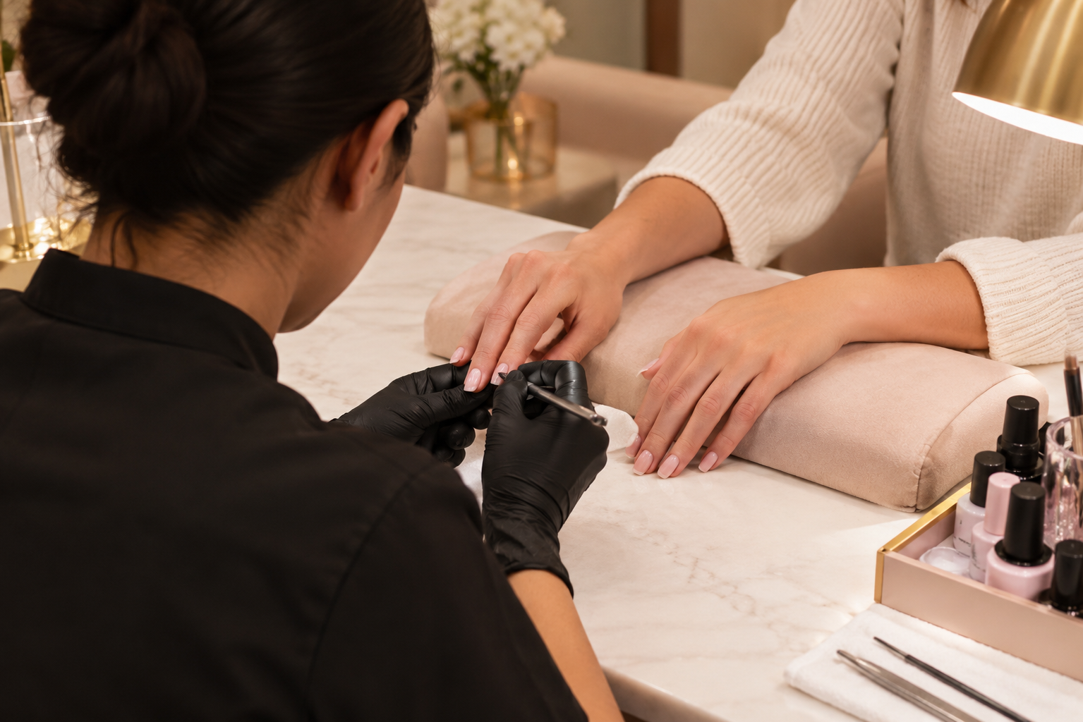 A specialist carefully shaping a client's nails at the studio